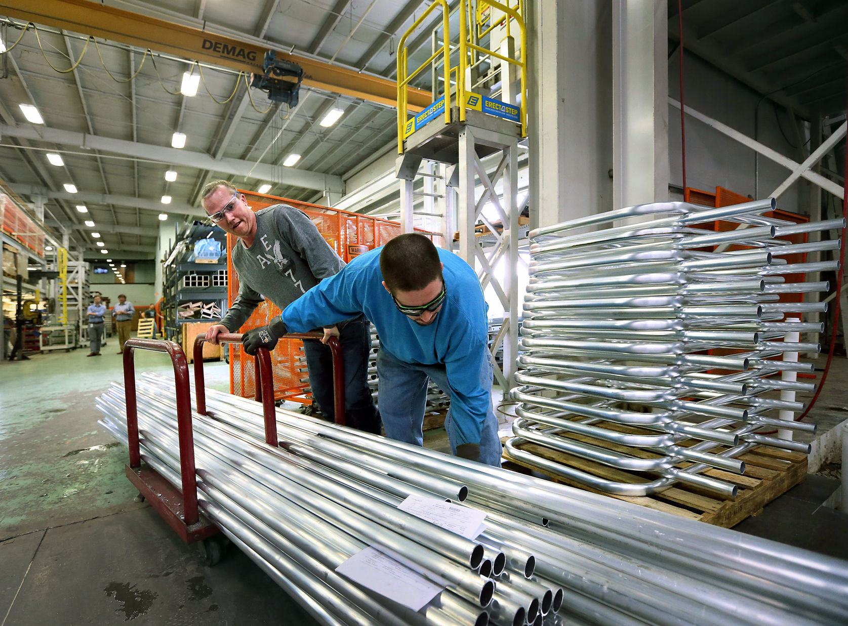 Workers move pipes